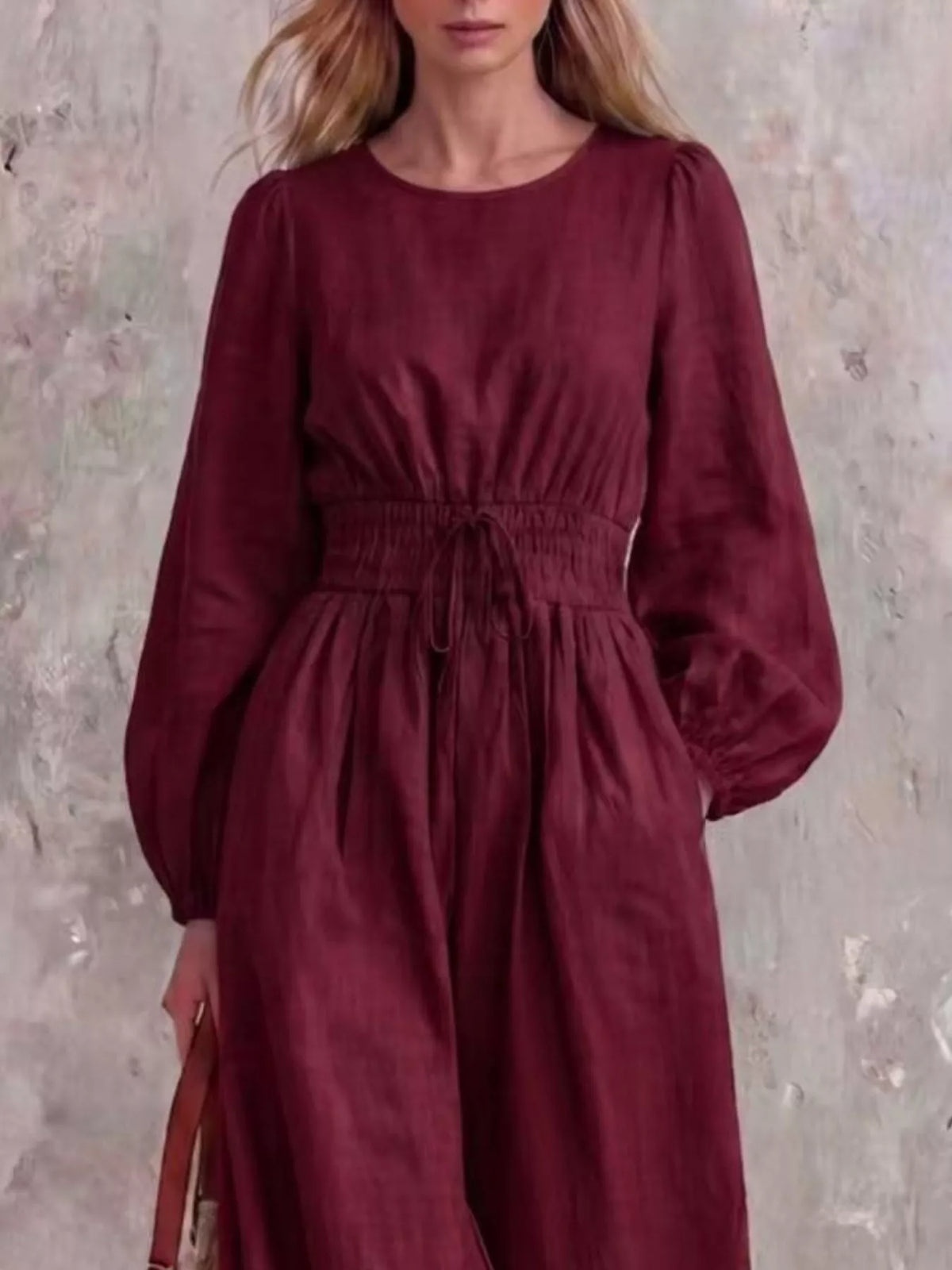 Smocked waist long-sleeve jumpsuit in wine red, draped skirt and balloon sleeves
