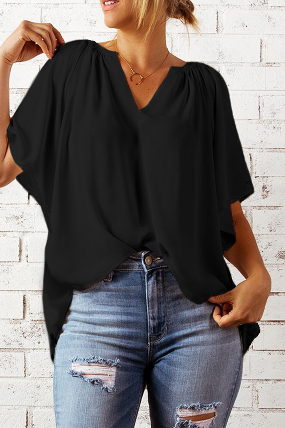 Black blouse with flutter sleeves and V notched neckline, flowy fit