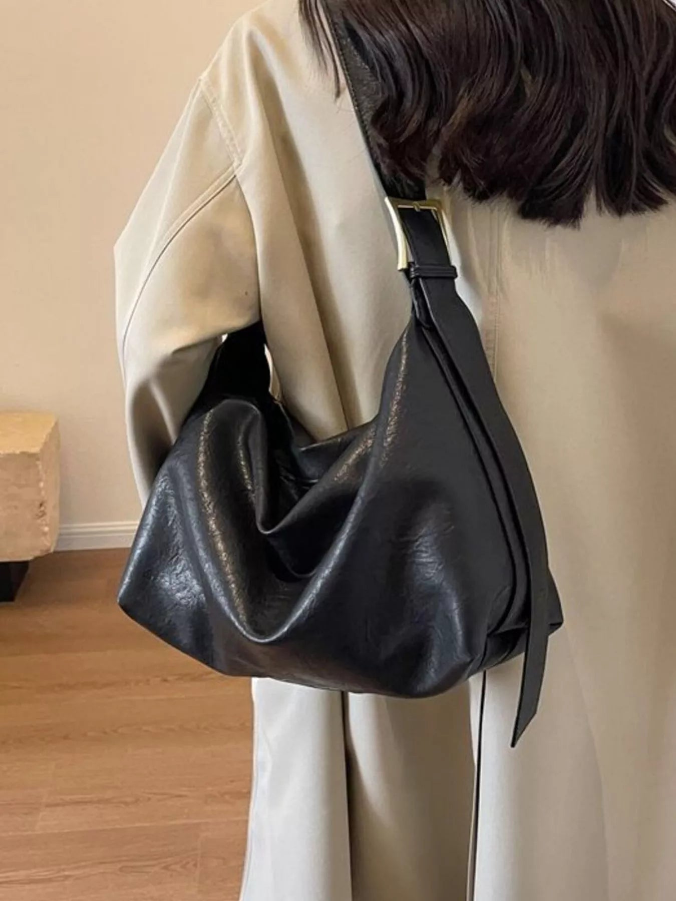 Adjustable strap shoulder bag by Trendsi, large black PU leather with gold-tone buckle.