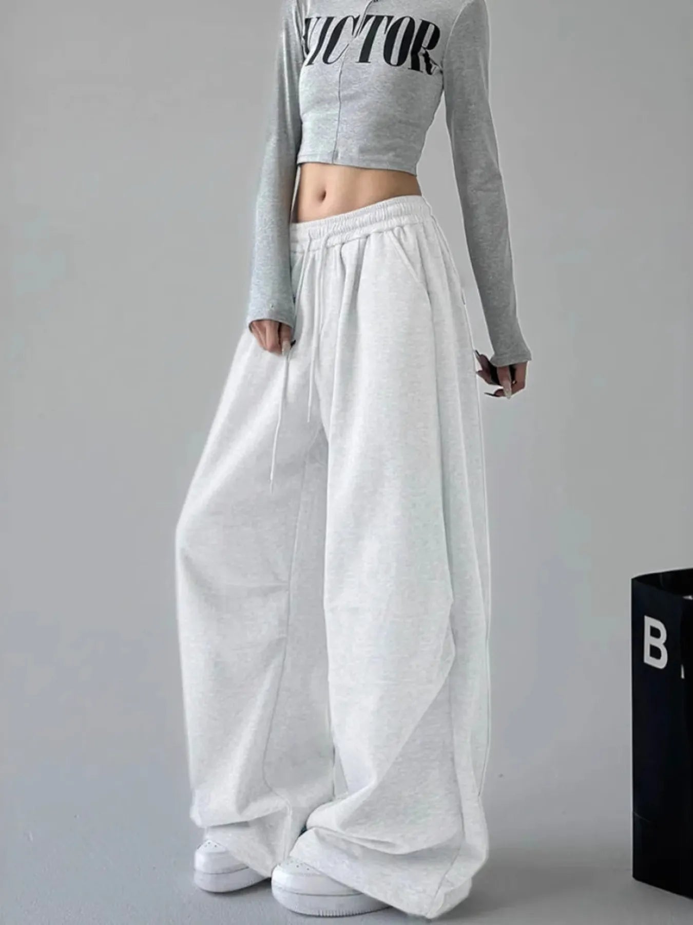 White oversized wide-leg drawstring pants with elastic waistband and long loose legs