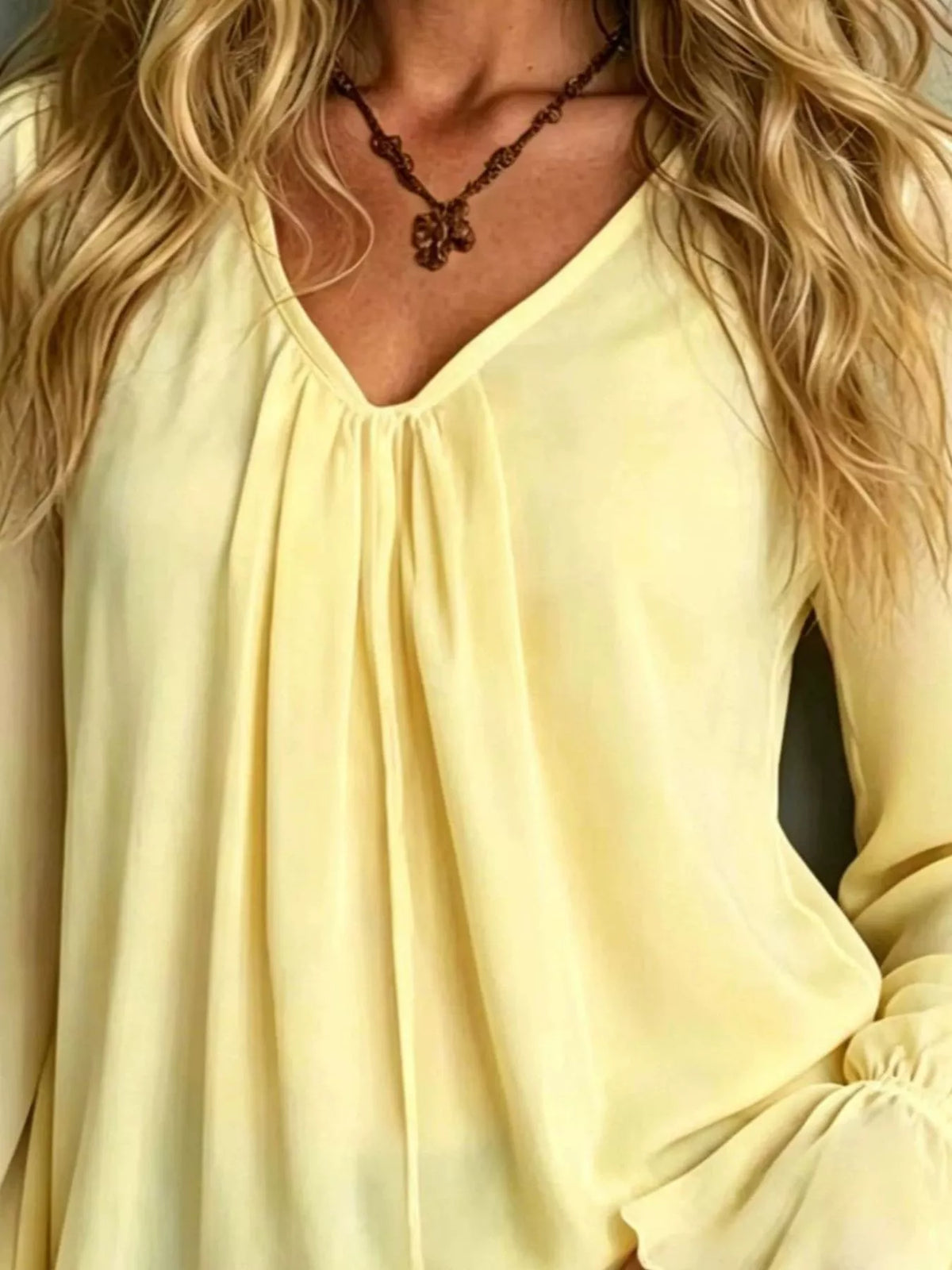 Pastel yellow v-neck polyester blouse with gathered front and long puffed flounce sleeves