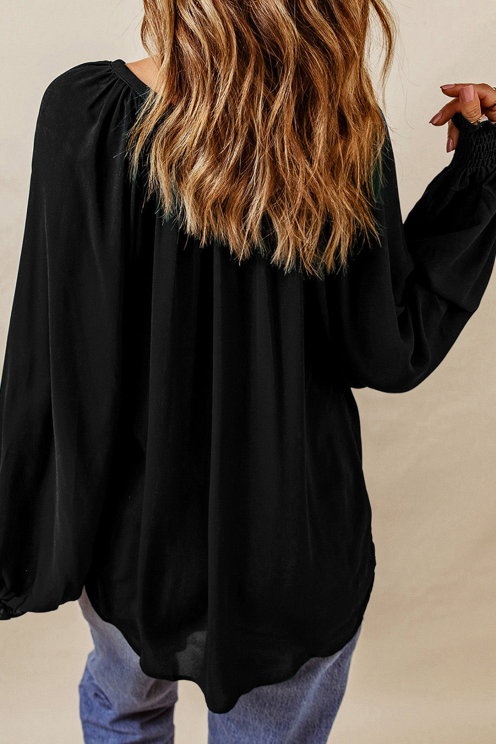Black V-neck lantern sleeve blouse with gathered elastic cuffs and loose body