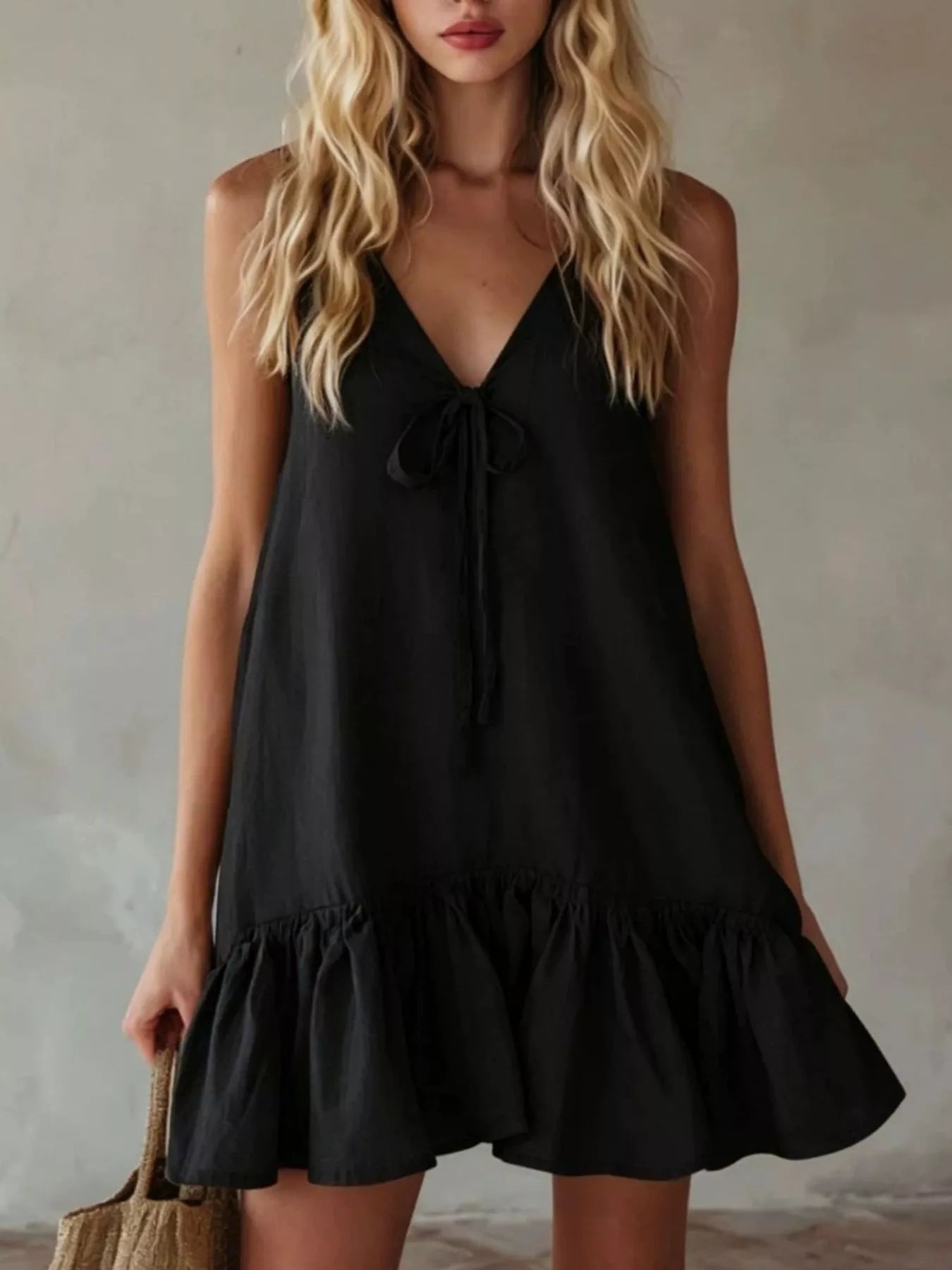 Black V-neck tie-front mini dress with sleeveless ruffle hem