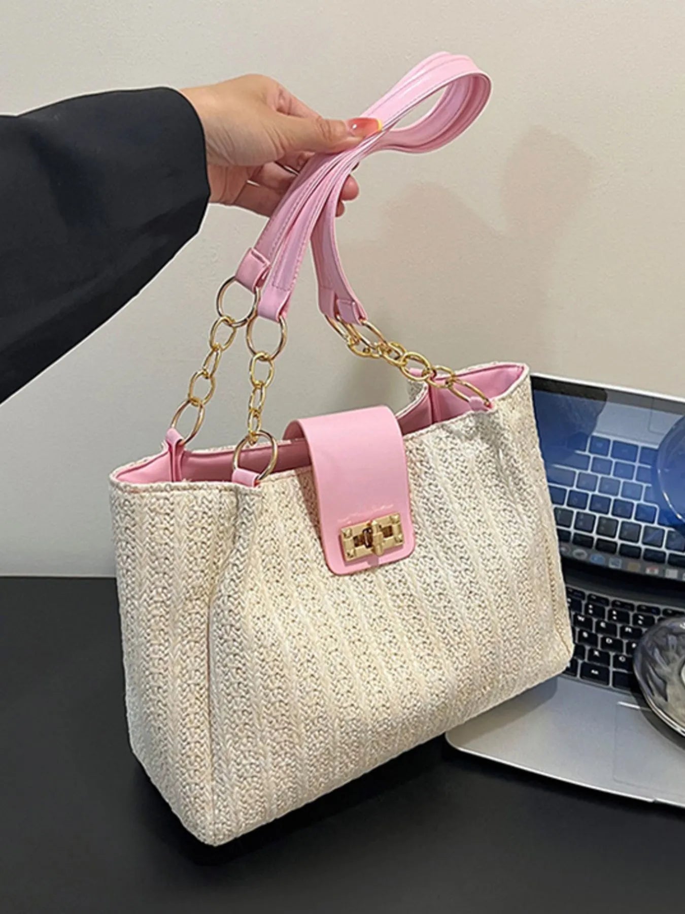 Woven straw shoulder bag with pink leather strap handles and gold-tone chain, beige weave