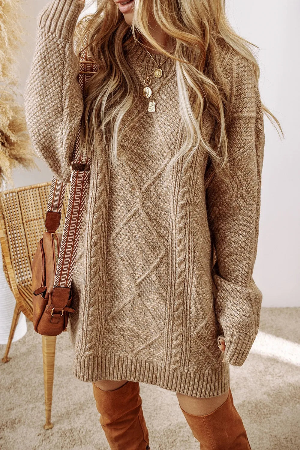 Tan cable-knit round neck sweater dress with long sleeves and layered button detail