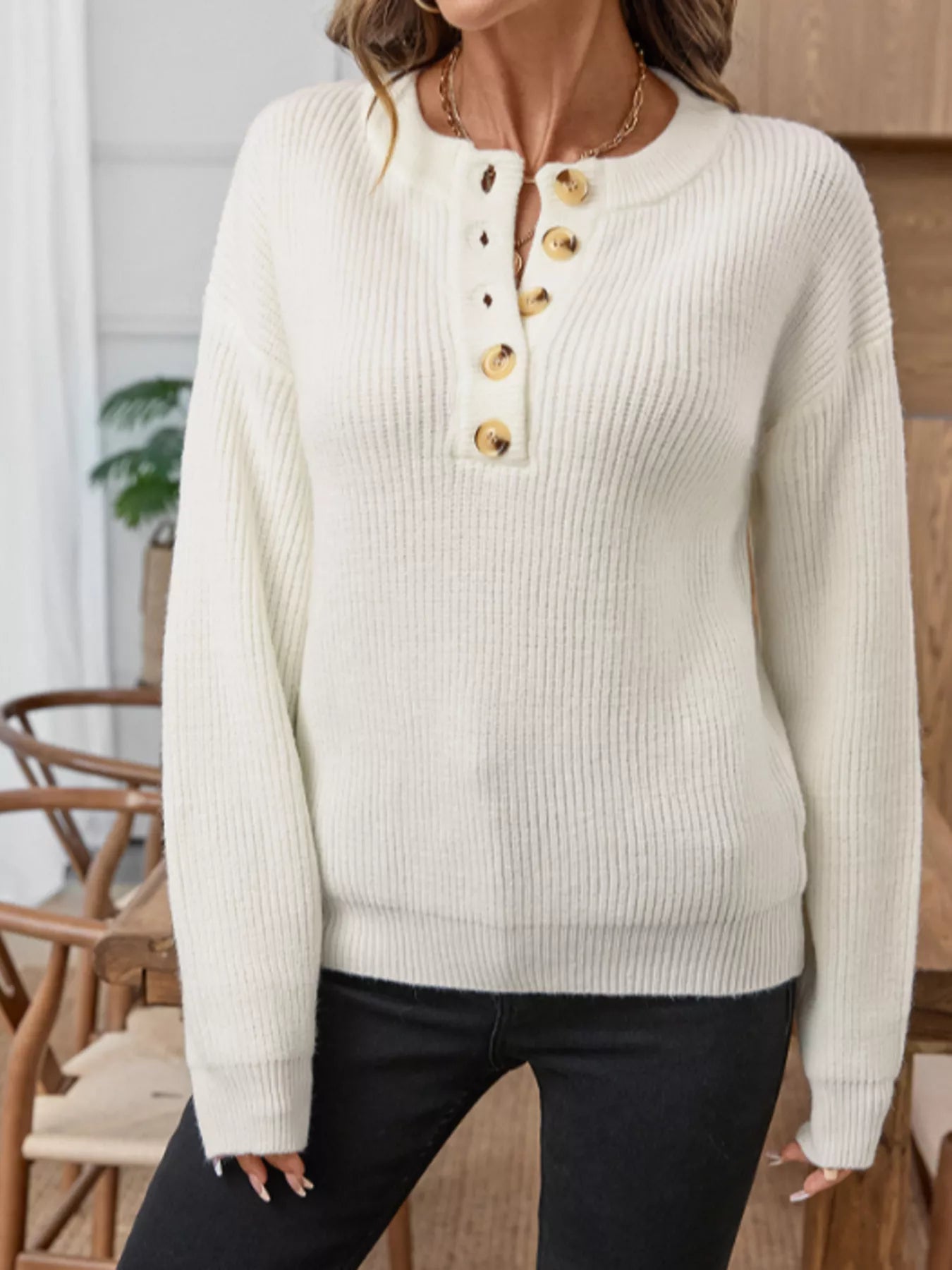 Cream knit sweater with vertical ribbing and front henley buttons