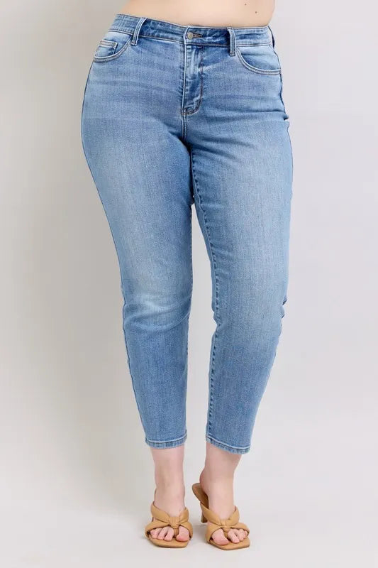Light blue mid-rise slim jeans with vintage wash and cropped ankle length, back view