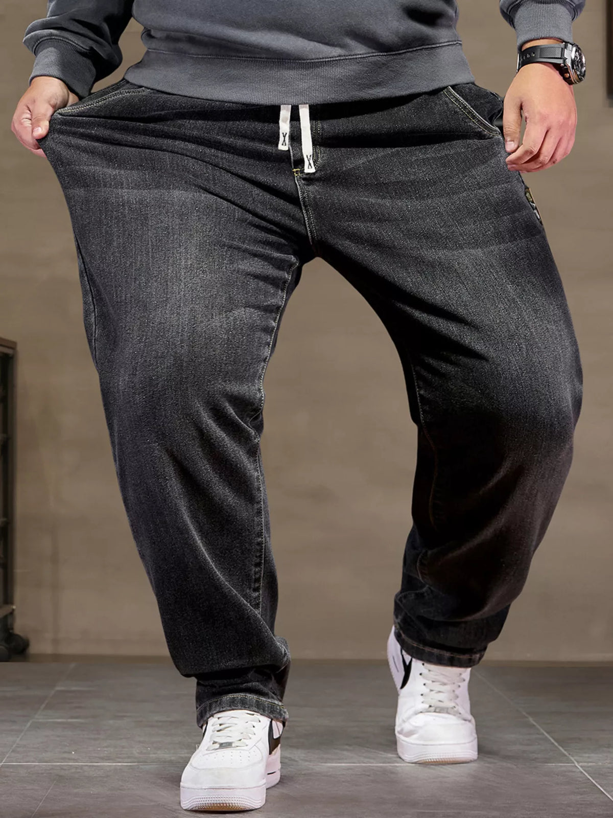 Men's black drawstring cotton jeans with drawstring waistband and relaxed tapered fit