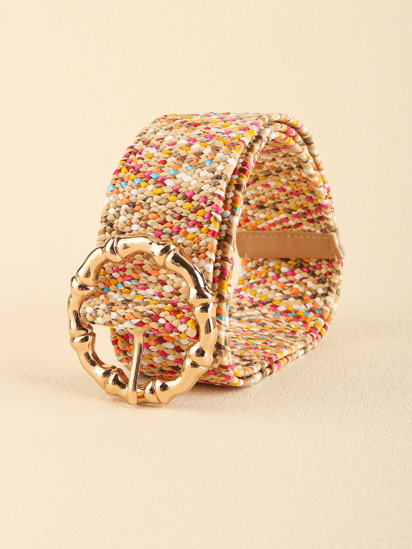 Multicolored wide belt shown side view with gold oval buckle and leather tabs