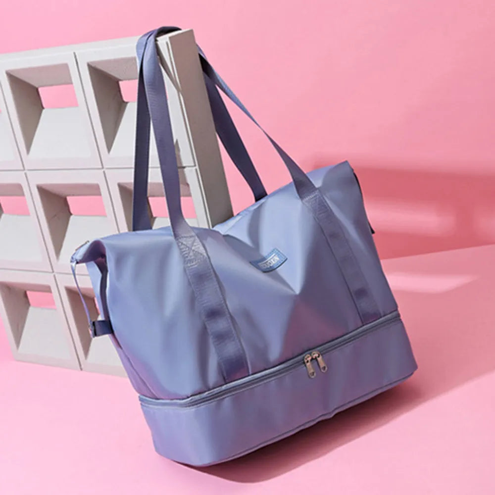Light blue nylon travel duffel bag with wide straps and front zipper pocket.