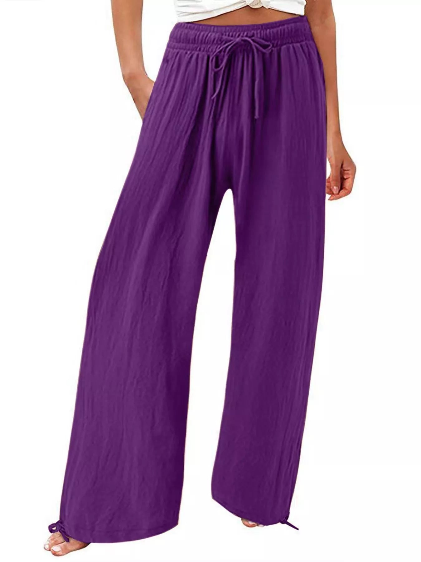 Purple wide-leg pants with drawstring waist and relaxed, flowing legs