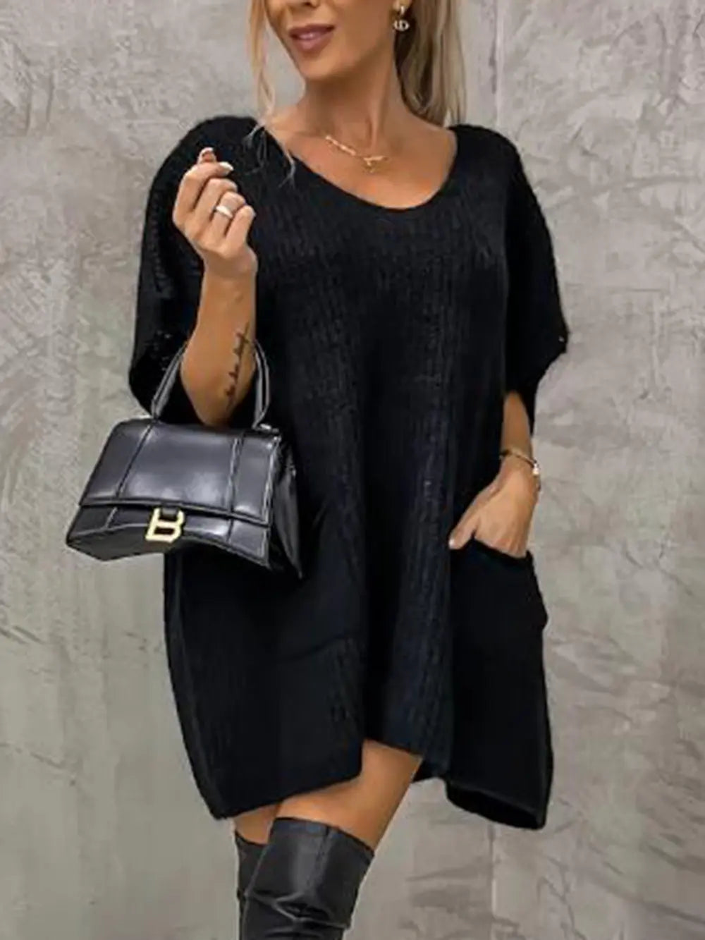 Black V-neck short-sleeve knit sweater with relaxed, tunic-length silhouette.