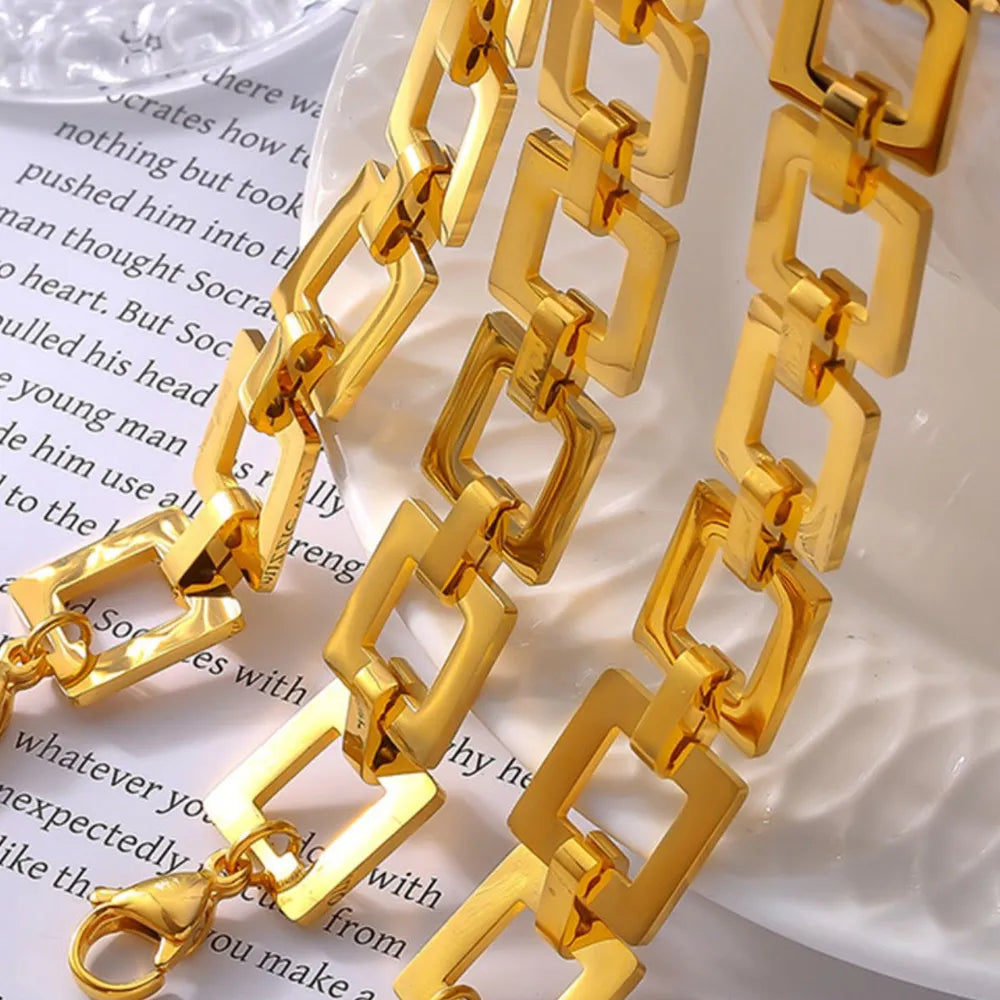 Gold hollow square link chain bracelet close-up on white card