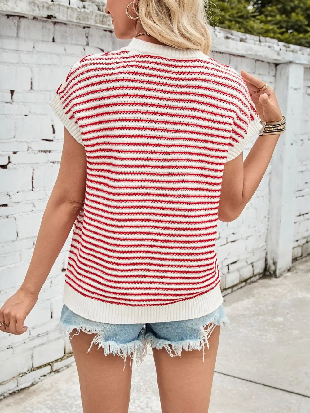 Back of red-and-white striped cap-sleeve sweater with round neck and ribbed hem