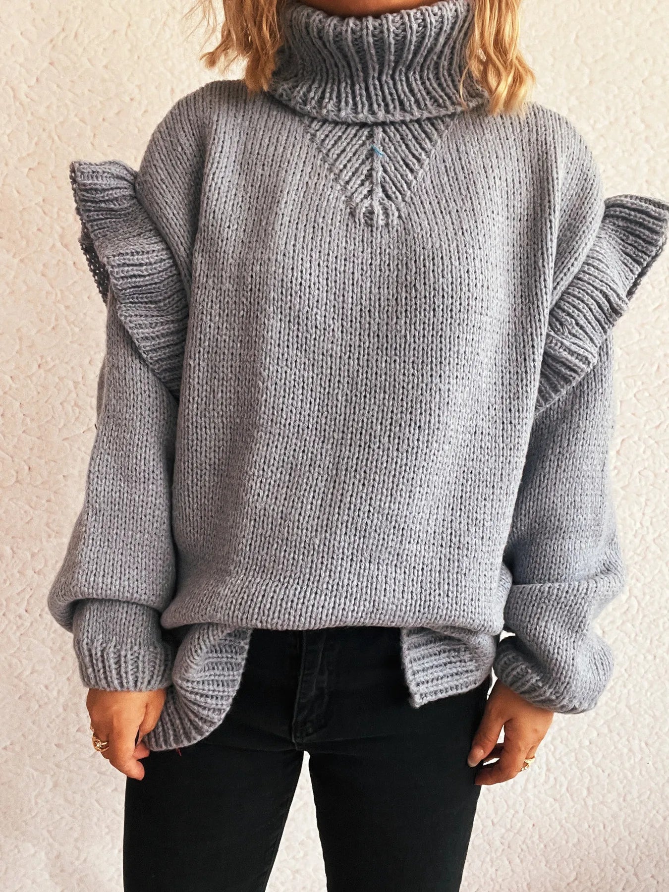 Grey ruffled turtleneck long-sleeve sweater with cable knit detail at chest