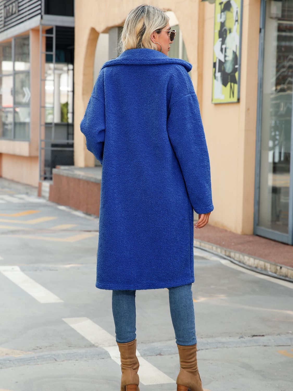 Royal blue collared coat with button front and long sleeves; back view