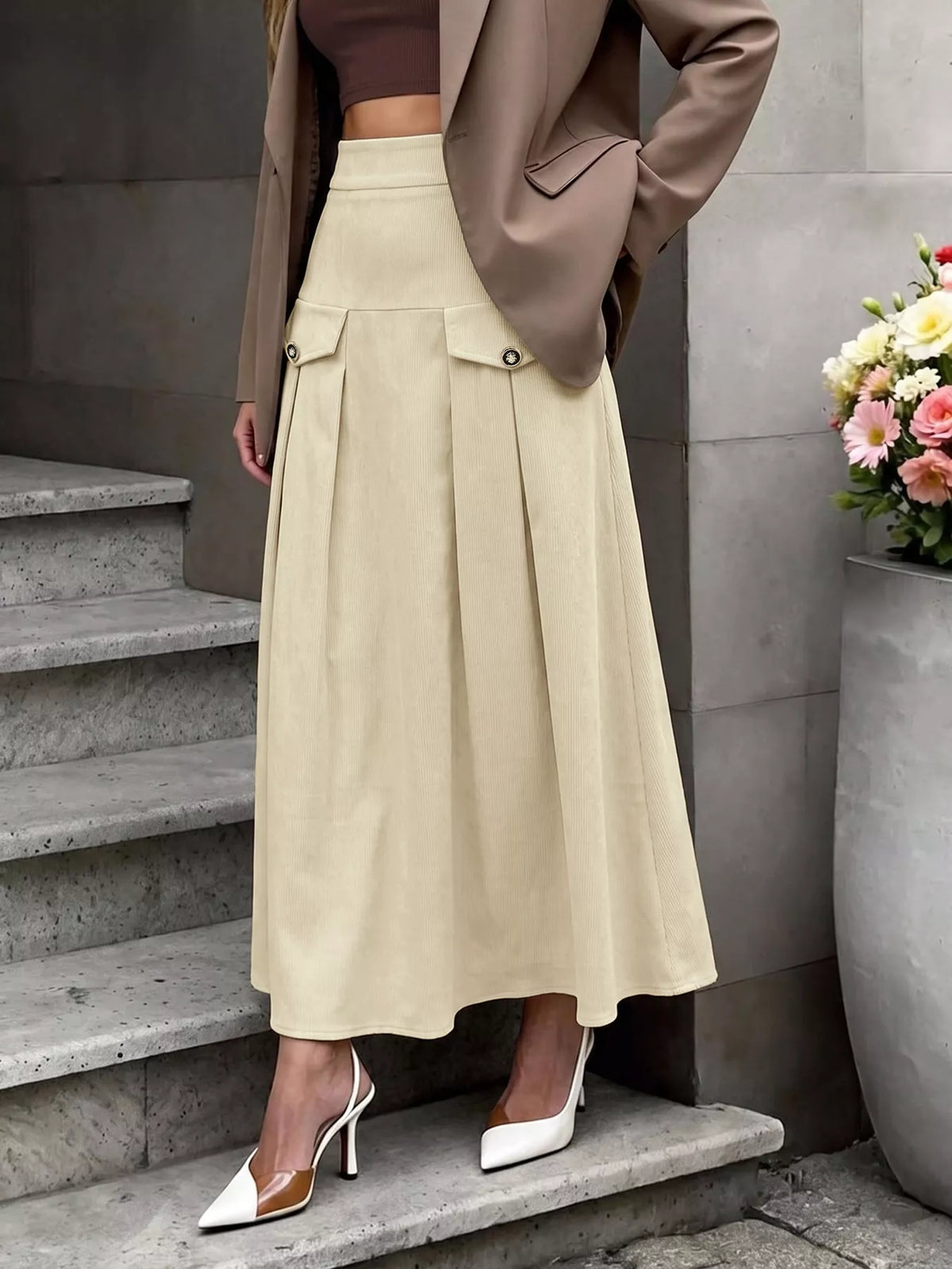 Khaki high-waist pleated midi skirt with front zipper and two flap pocket details