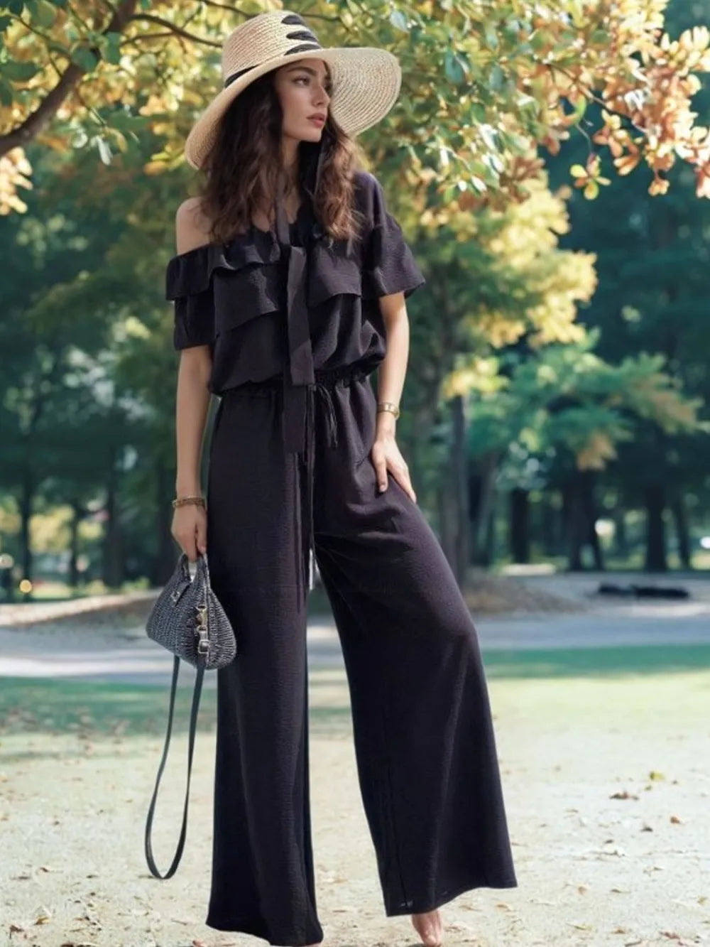Black off-shoulder ruffled wide-leg jumpsuit with tiered neckline and relaxed fit