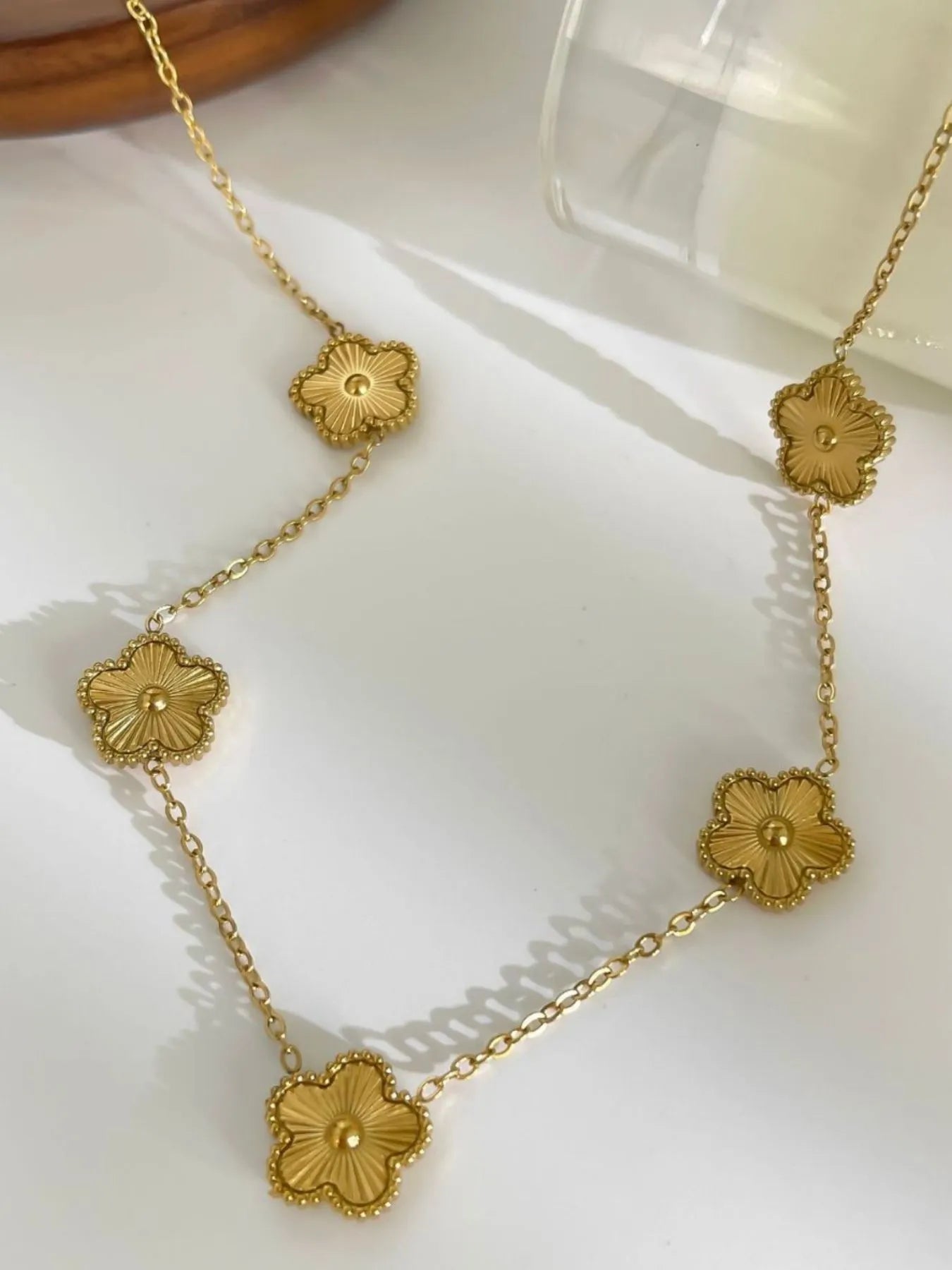 18K gold-plated flower chain necklace featuring five gold flower medallion charms