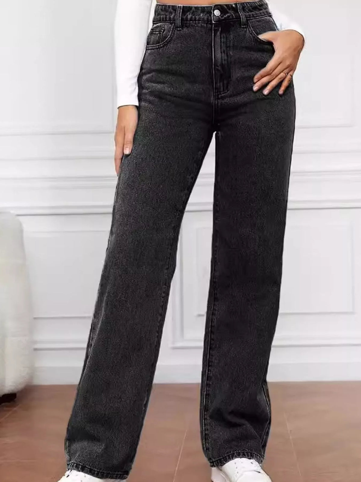 High-waisted vintage wash black denim jeans with straight wide leg and front button closure