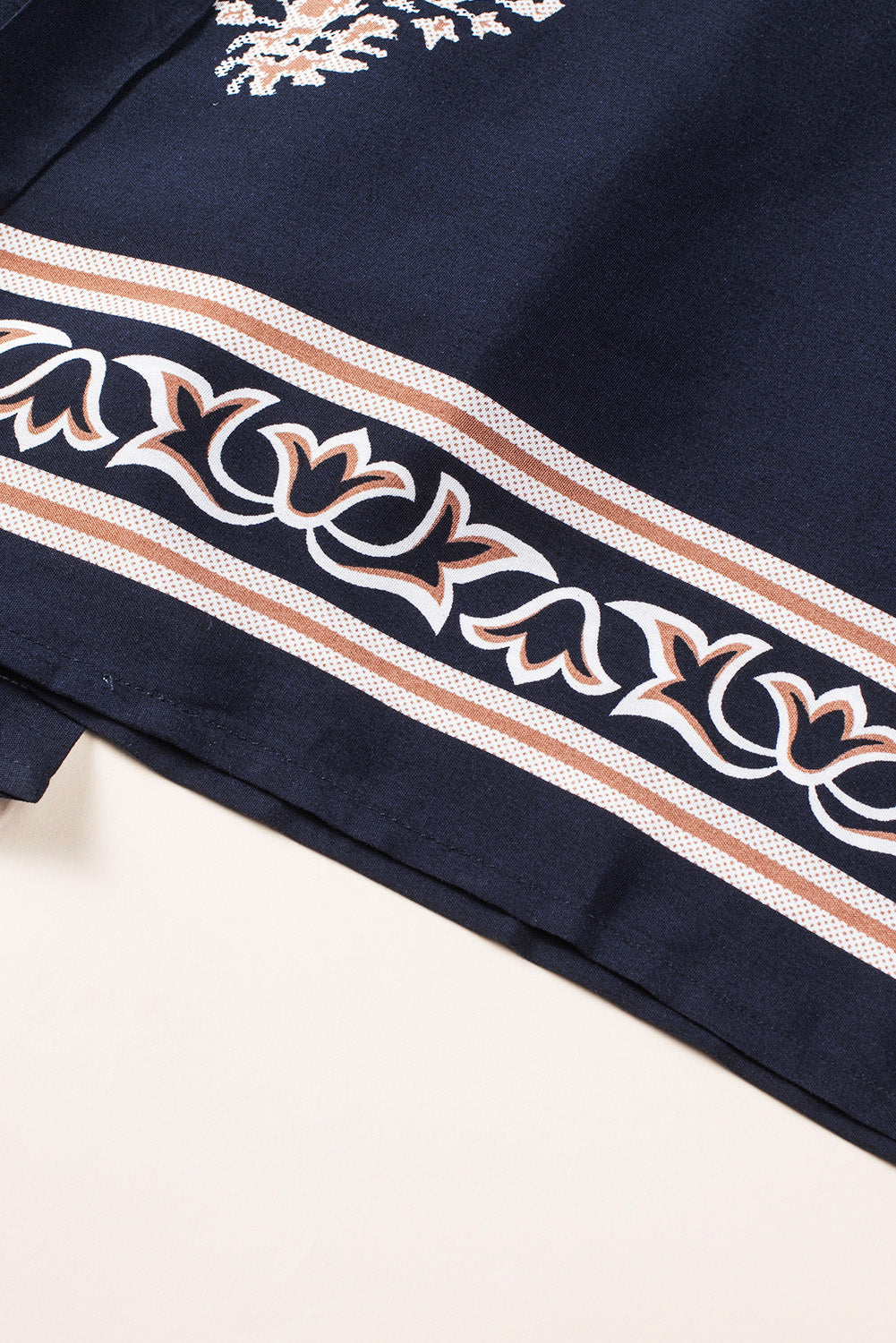 Dark blue jumpsuit hem with striped decorative border
