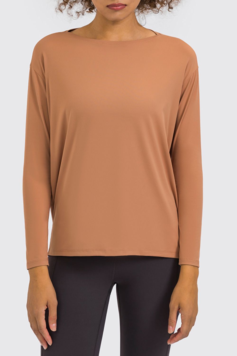 Loose fit active top in tan, three-quarter sleeve and loose silhouette with crew neck.