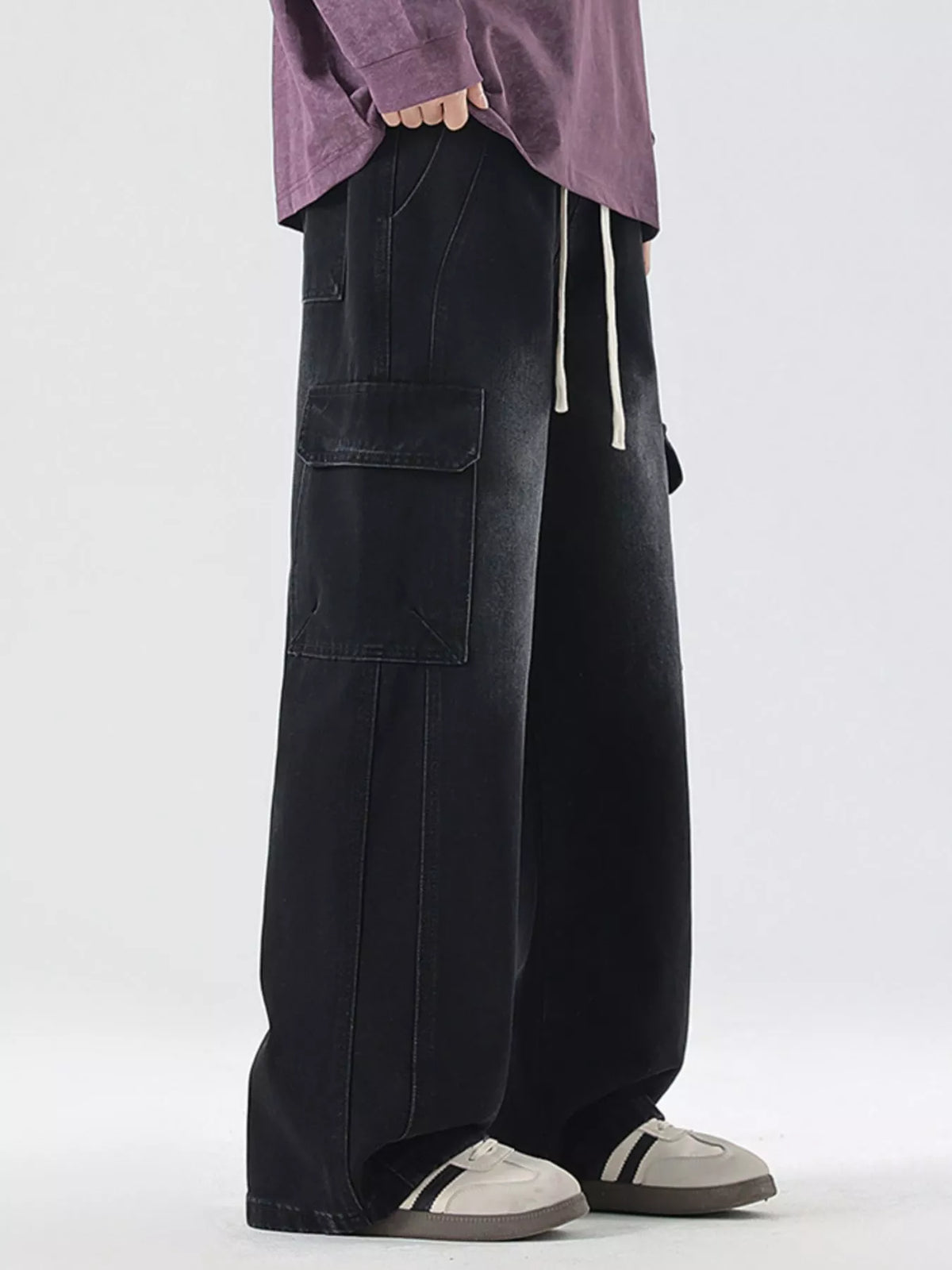 Washed black wide-leg cargo jeans with square cargo pockets and side seam stitching