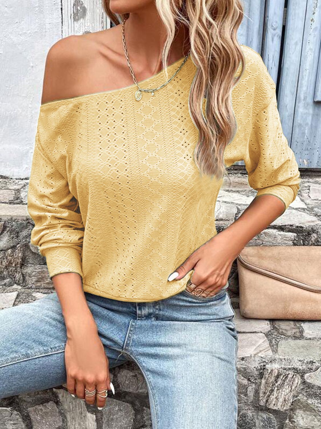 Yellow eyelet one-shoulder blouse with long sleeves and relaxed fit