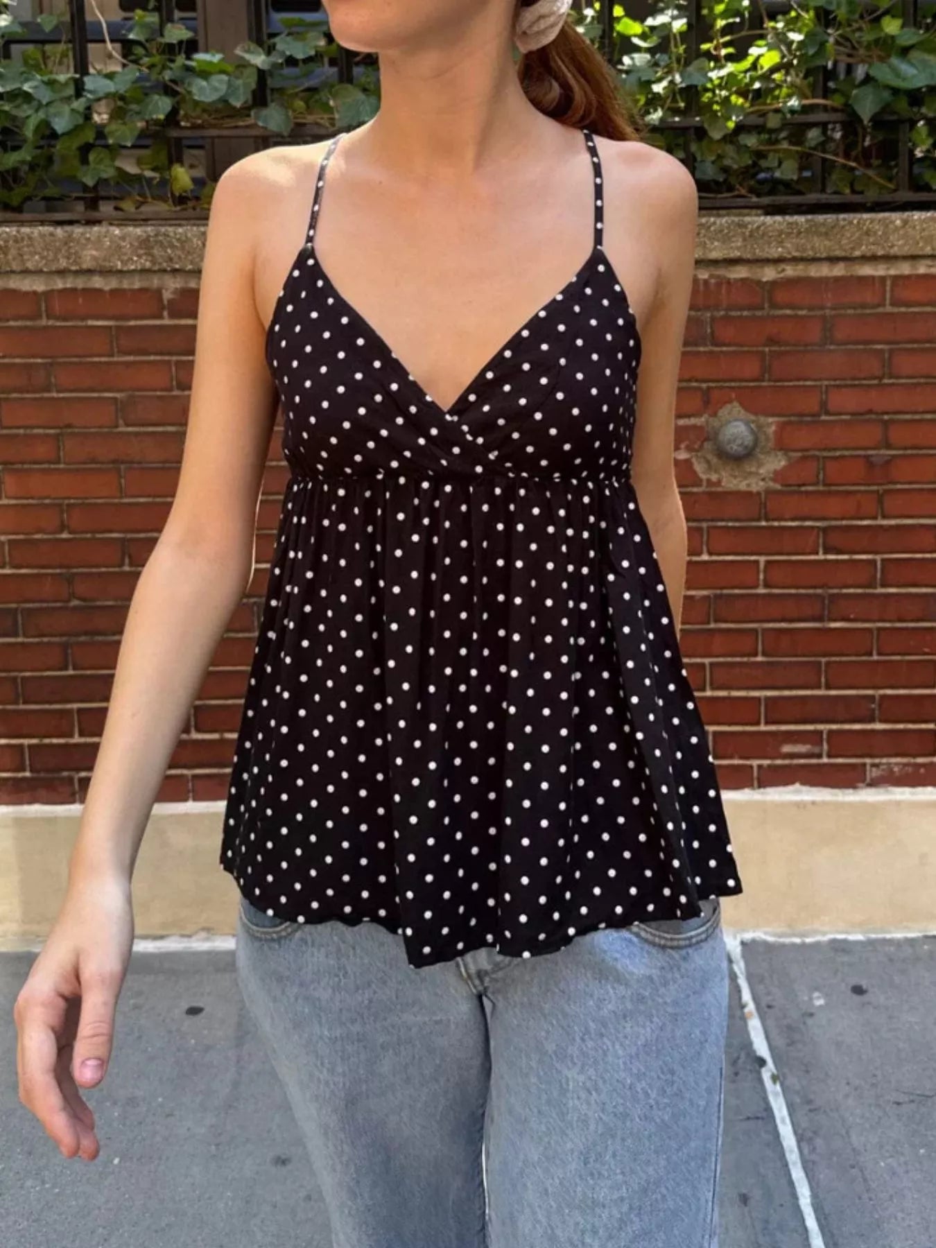 Dark blue polka dot V-neck flowy cami with thin straps and short gathered hem