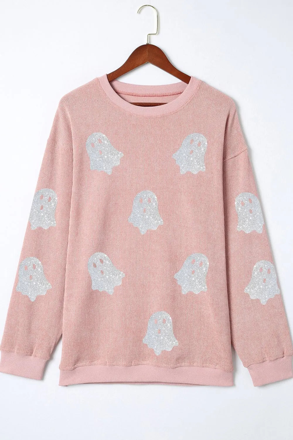 Pale blush crewneck sweatshirt with scattered light-blue ghost graphic prints on front