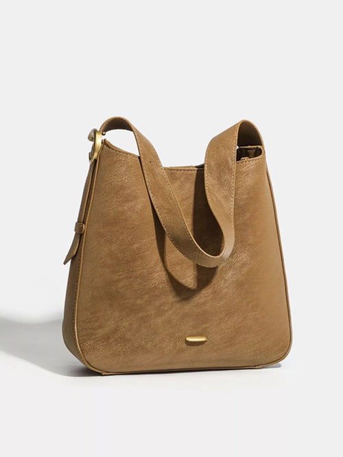 Brown faux leather hobo shoulder bag with slouch shape and gold-tone snap closure.