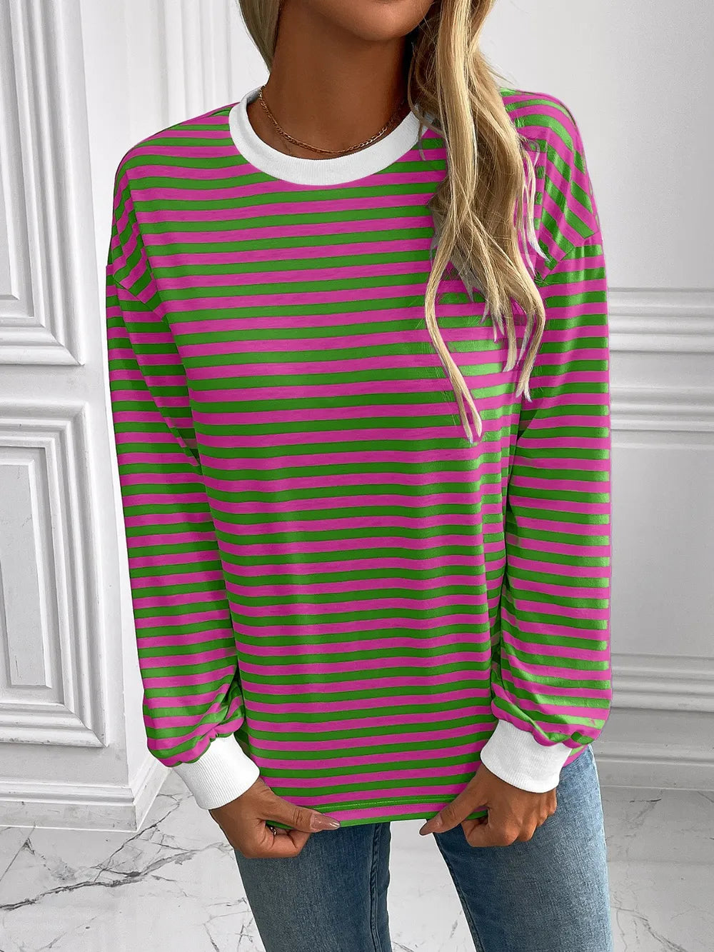 Green and pink striped round-neck sweatshirt with long sleeves and white collar