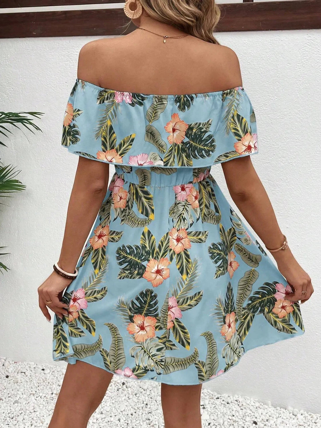Printed off-shoulder floral mini dress in light blue with tropical hibiscus flowers and leaves