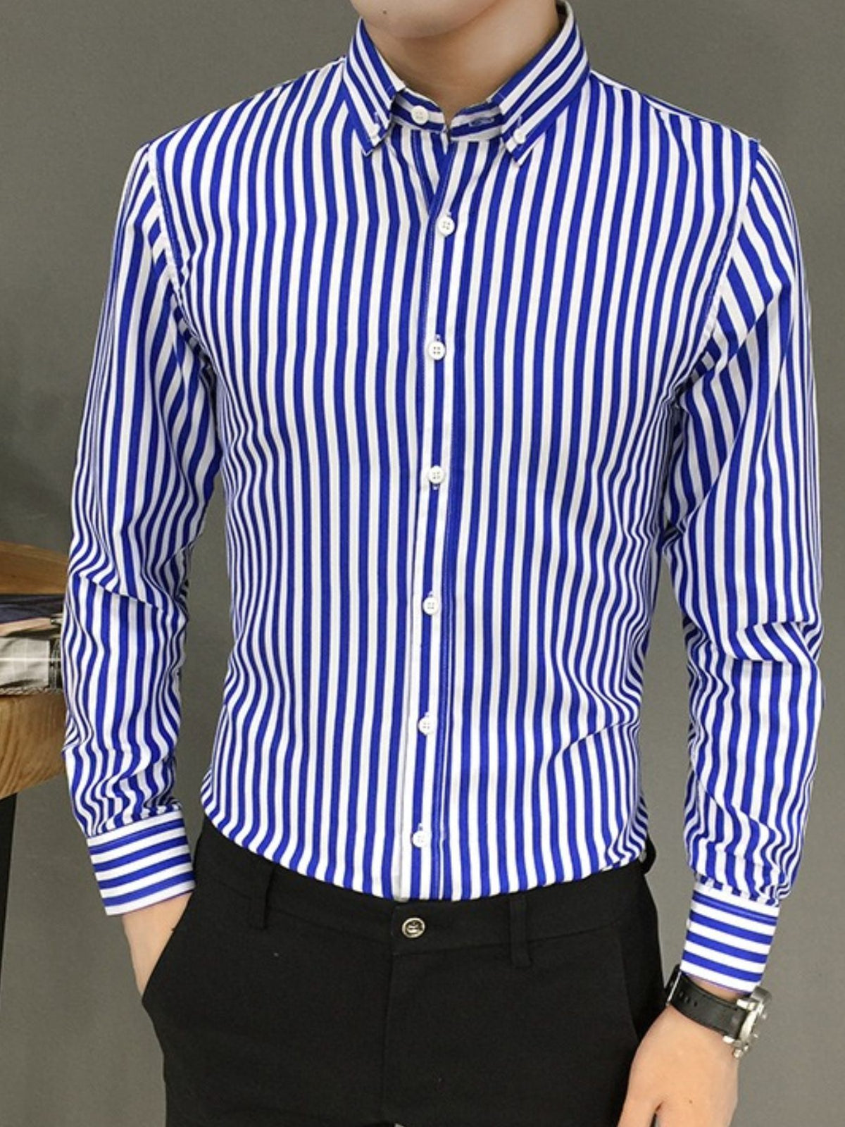Men's blue-and-white striped button-up long-sleeve shirt with collared neckline and buttons.