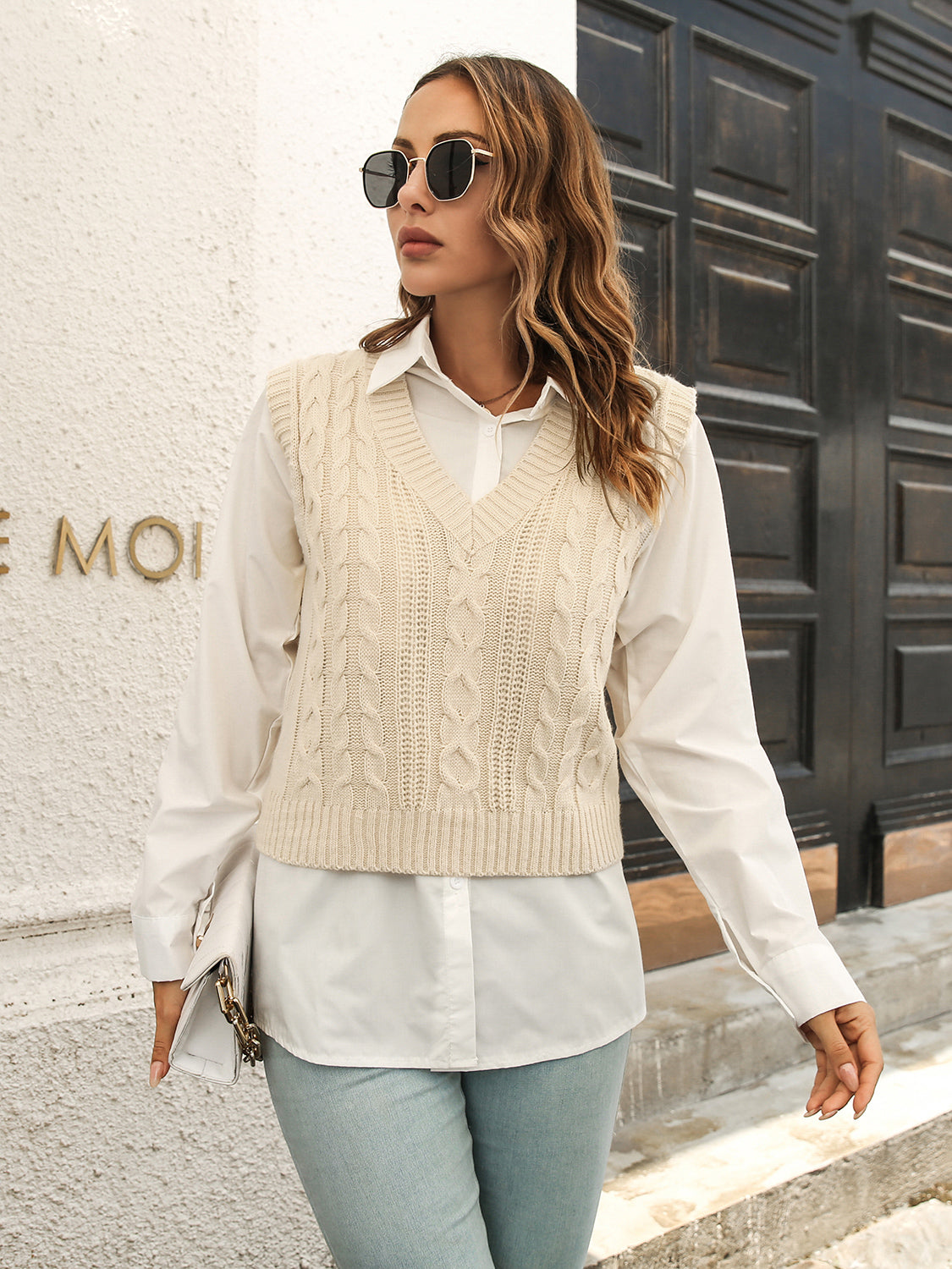 Ivory V-neck cable knit sweater vest with textured knit pattern