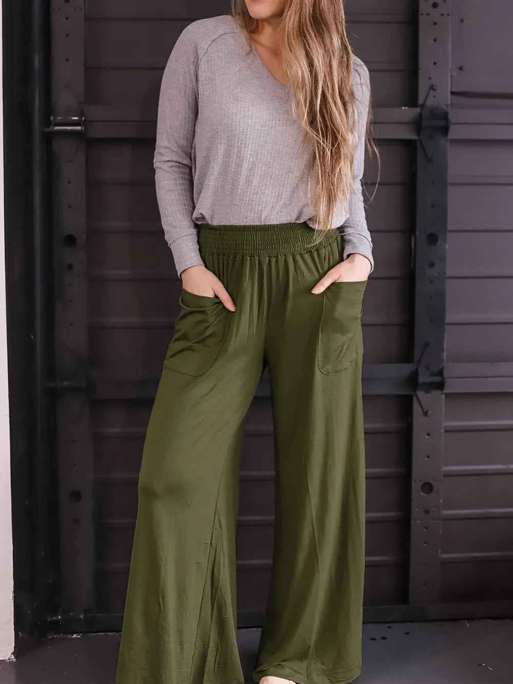 Moss green wide-leg pants with elastic waist and side pockets, front view with drape