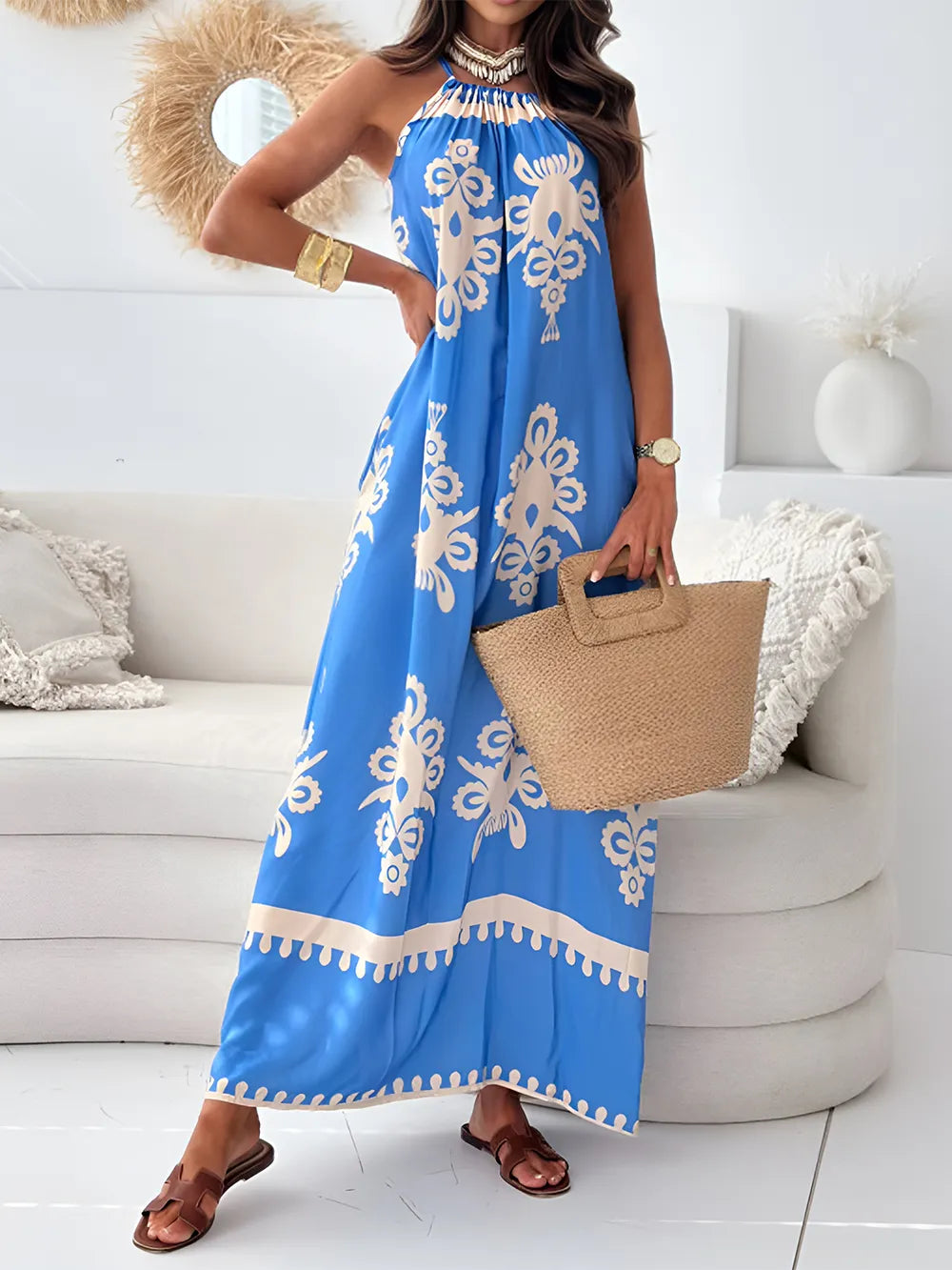 Blue printed maxi dress with spaghetti straps, ruffled neckline, and cream floral border trim