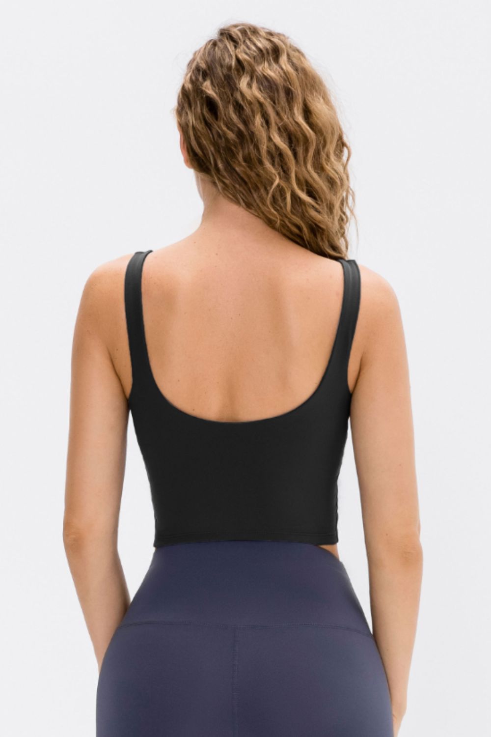 Cropped scoop neck active tank top, black; open scoop back with racerback straps.