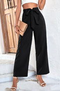 Black belted high-rise wide-leg pants with bow-tie waistband, side view