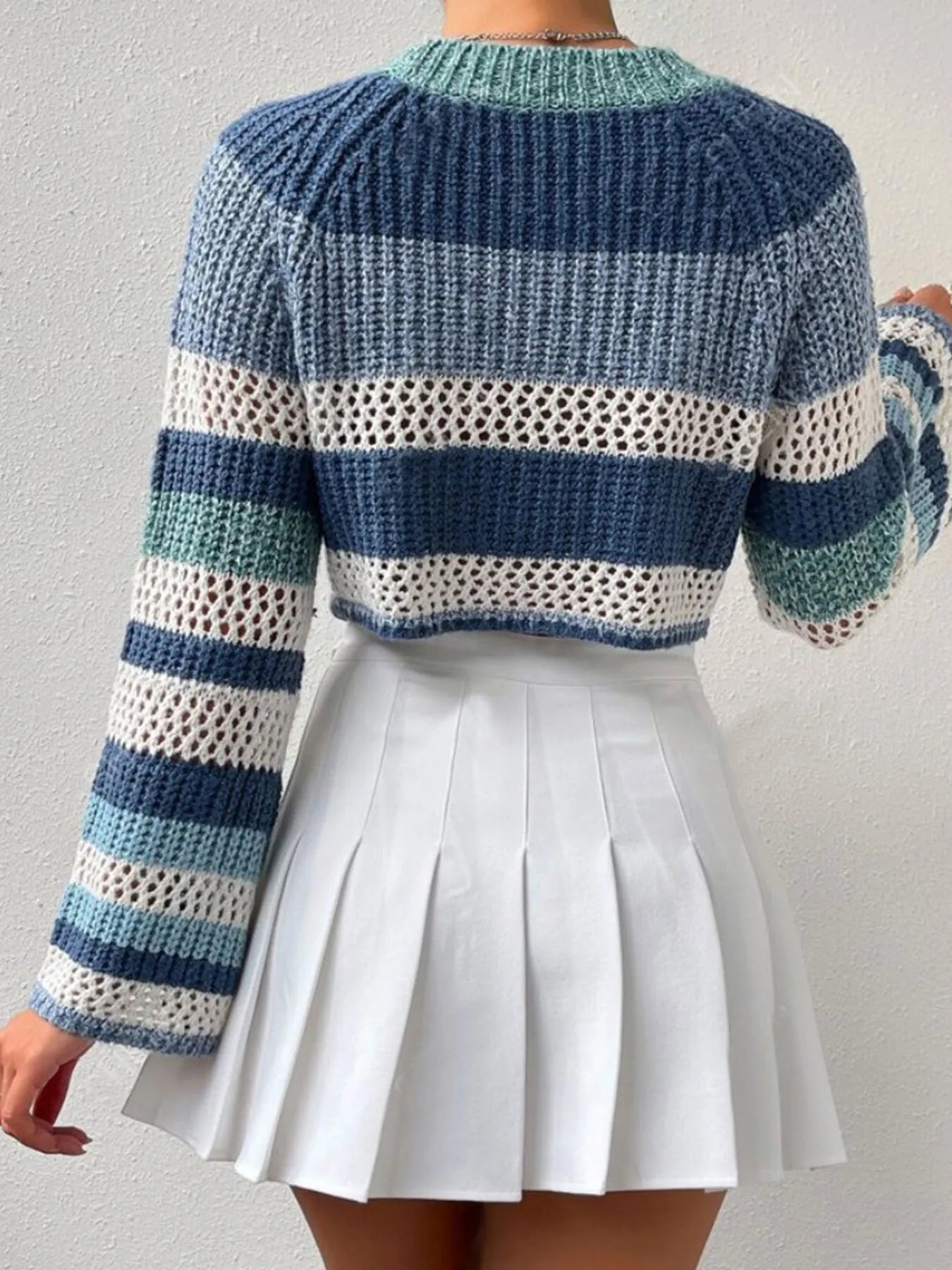 Striped color block crop sweater with openwork knit, ribbed crew neckline, and striped bands