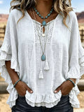 White tie-neck polyester blouse with ruffled hem and lace yoke detail