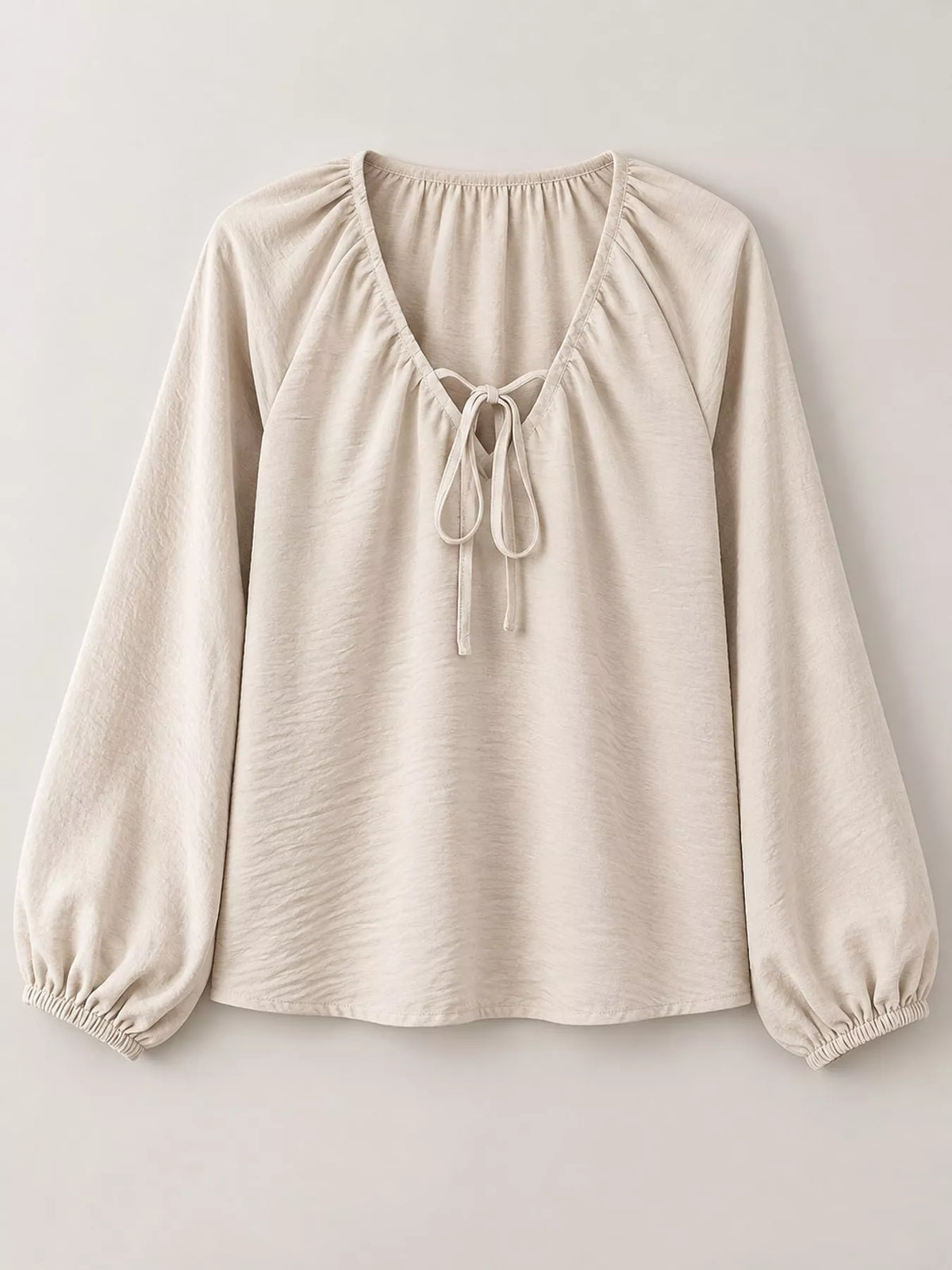 Apricot blouse front with v-neck tie and elastic balloon sleeves