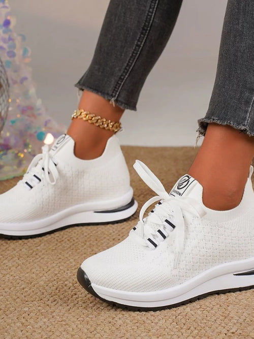 White mesh lace-up sneakers with black accents and white rubber sole