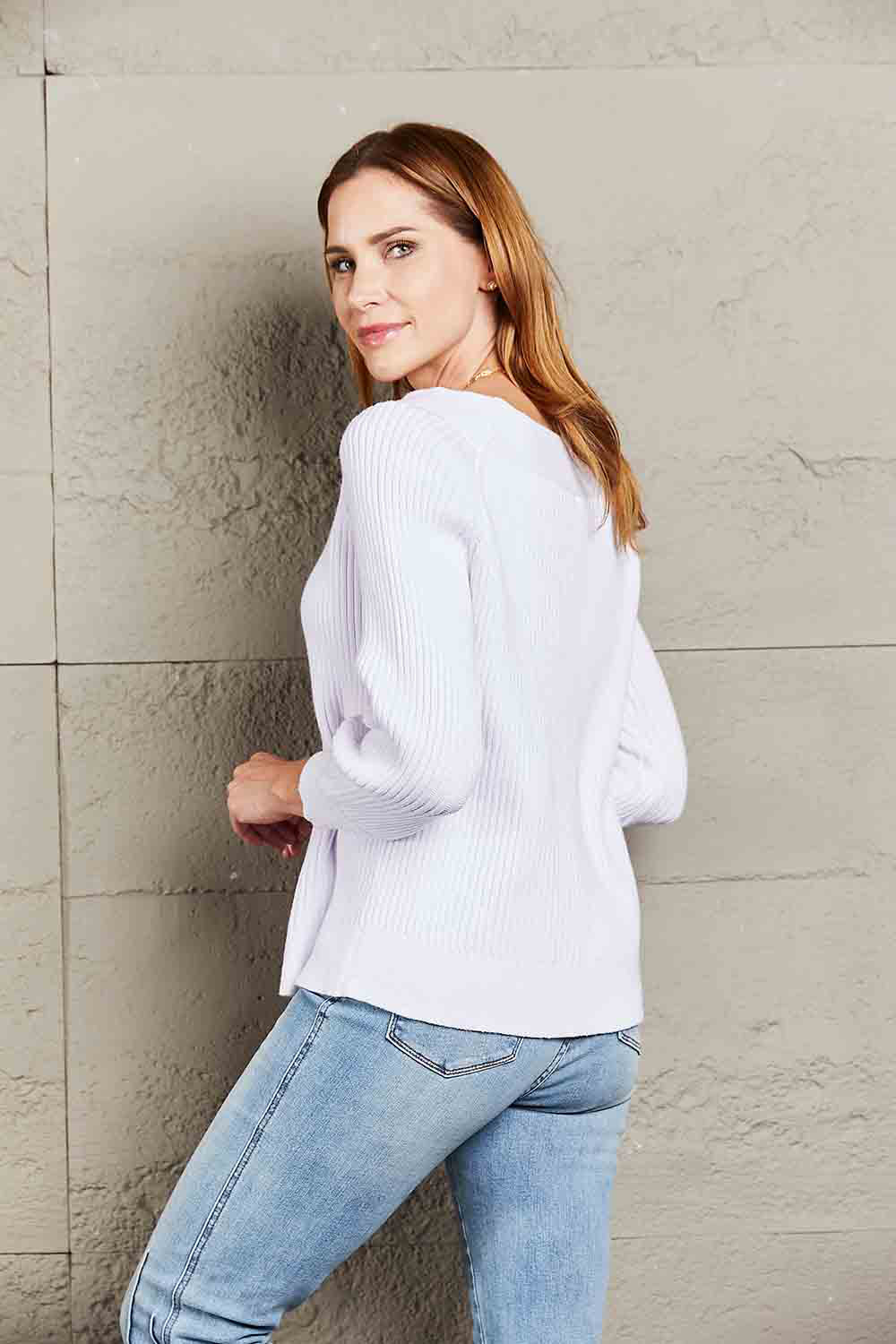 White off-shoulder rib-knit sweater with drop-shoulder silhouette and long sleeves.