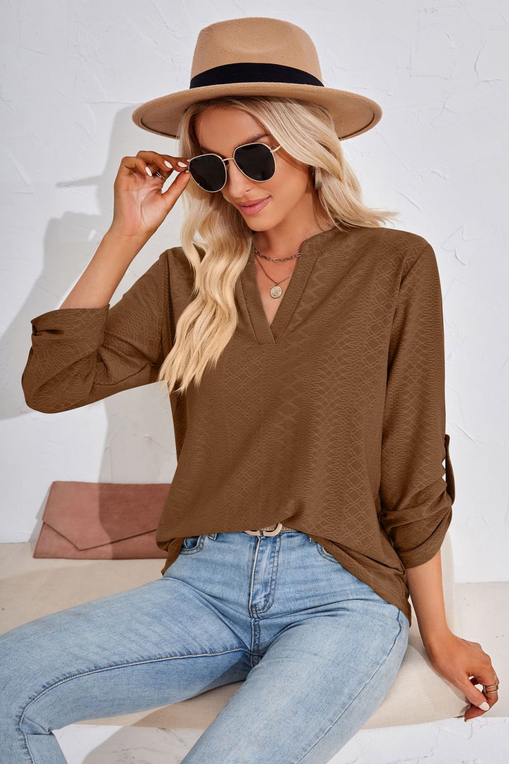 Brown V-neck roll-tap sleeve blouse with textured pattern, 3/4 sleeves and front yoke