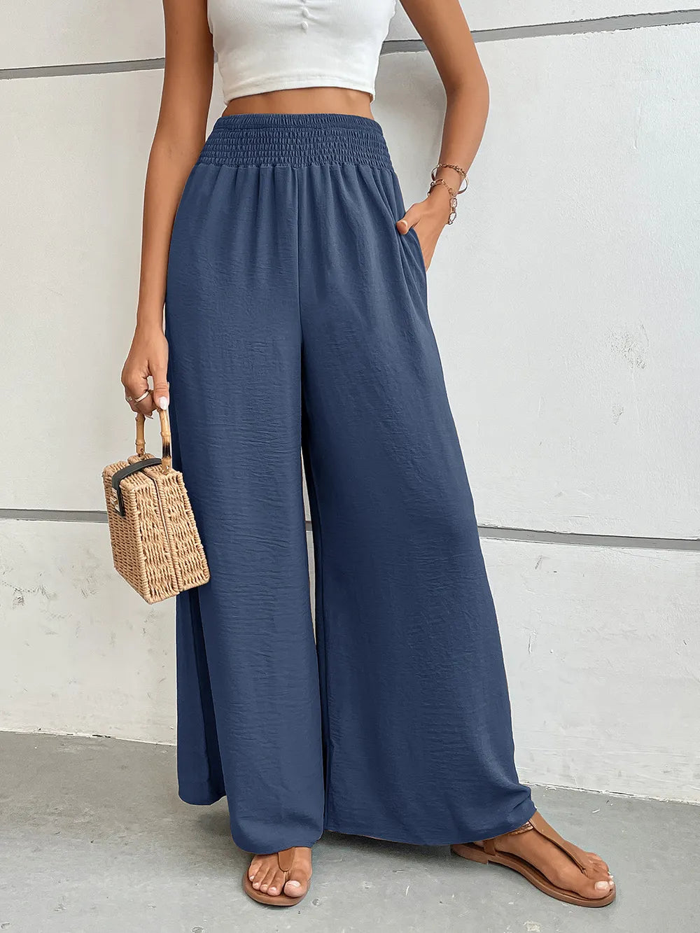 Wide-leg pants with pockets, dusty blue textured fabric, elastic waistband.