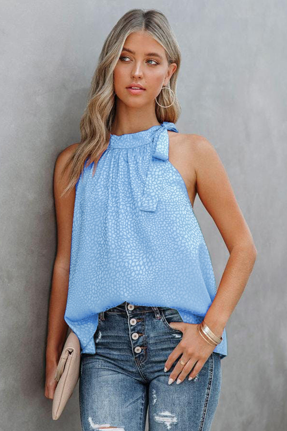 Light blue printed Grecian neck tank with high tied neckline and sleeveless silhouette