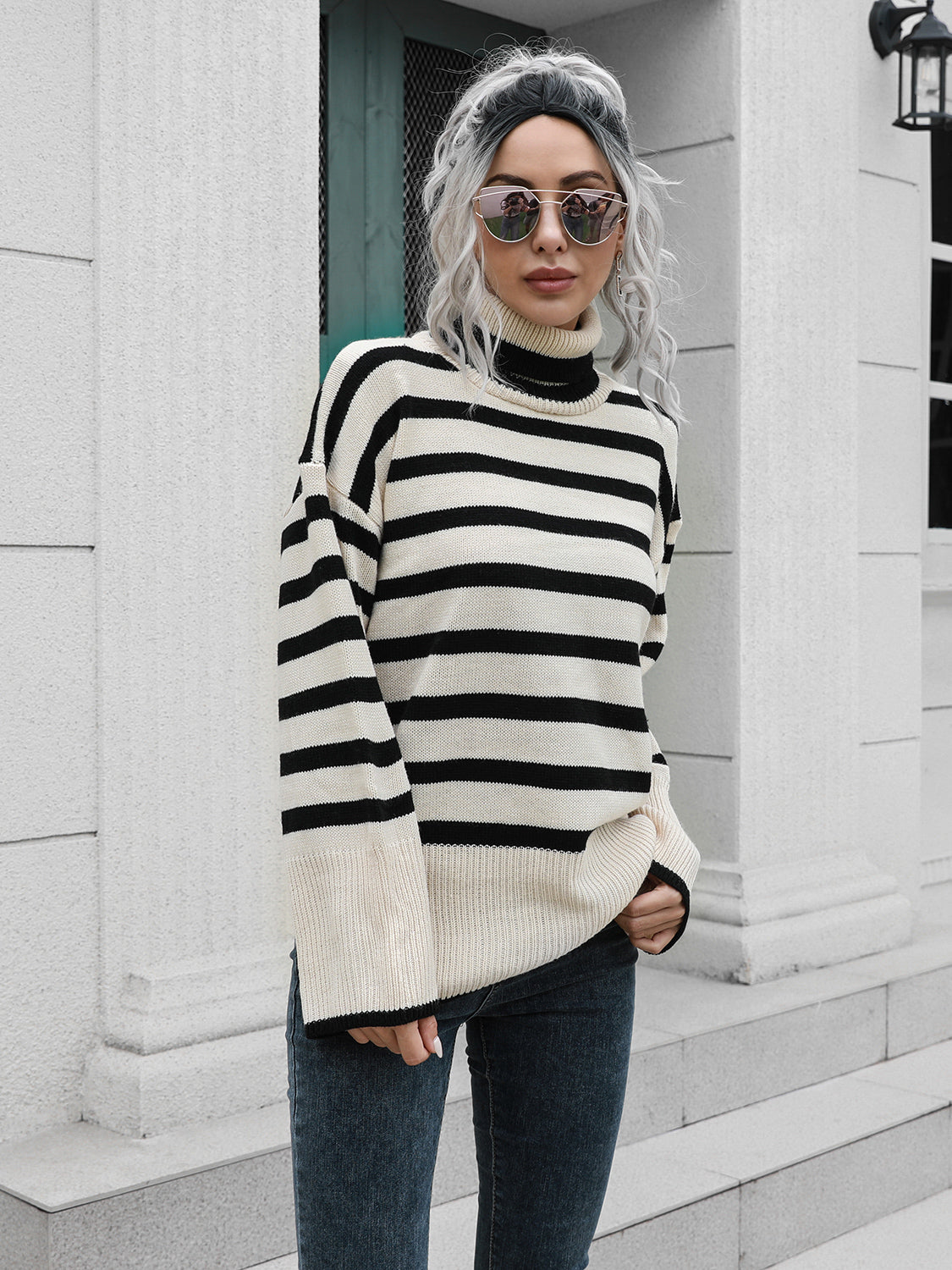 Black-and-white striped turtleneck sweater with drop shoulders and ribbed collar