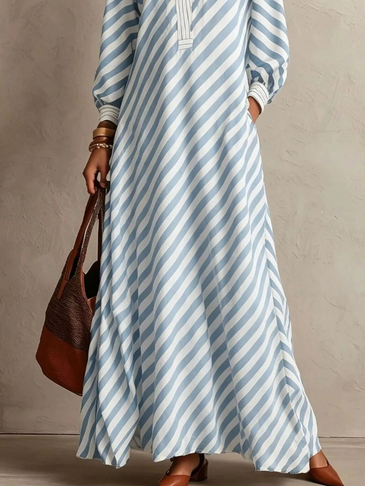 Light blue striped maxi dress with long sleeves, V-neck, and flowy skirt