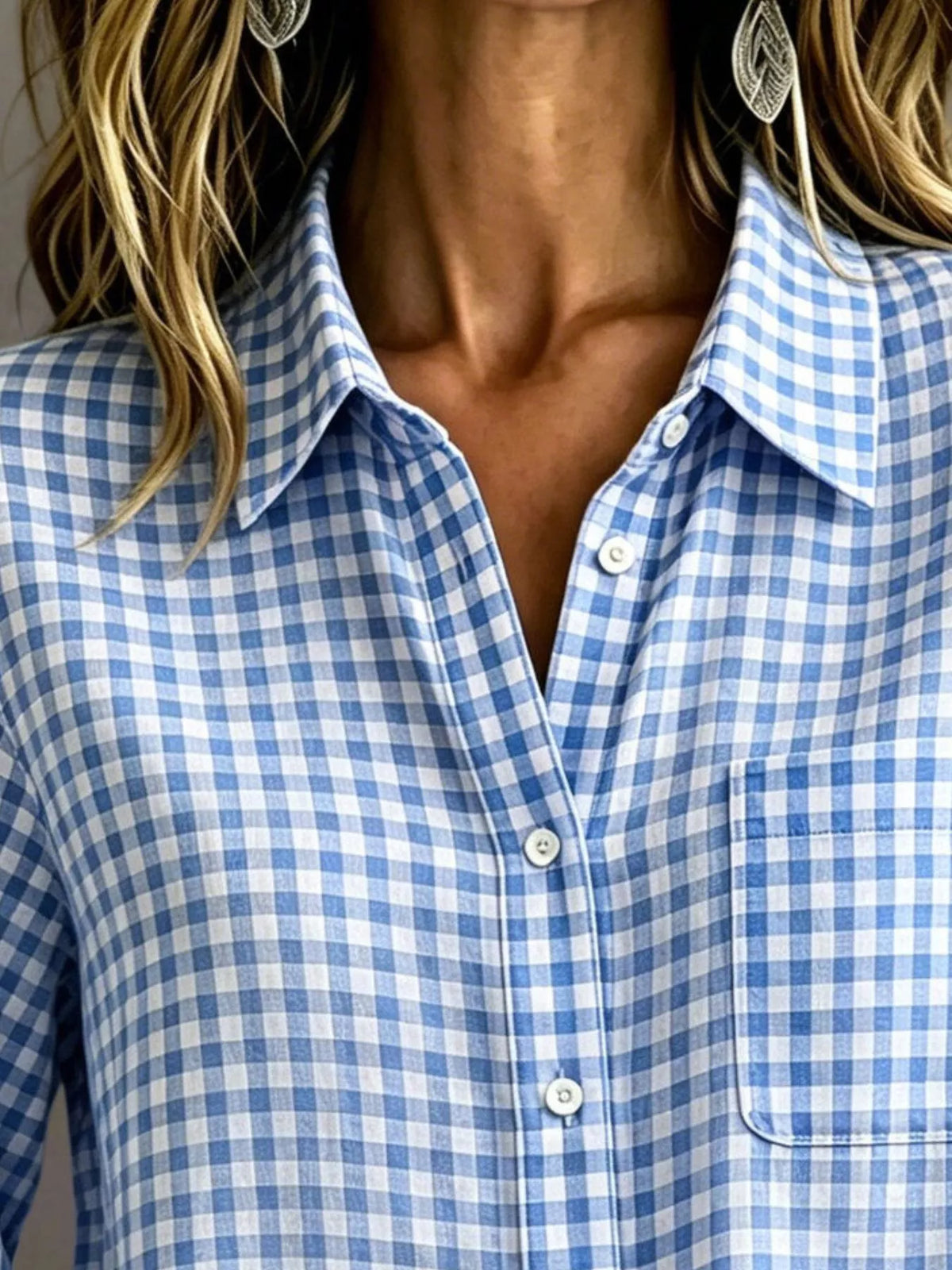 Light blue gingham button-down shirt close-up with button placket and chest pocket